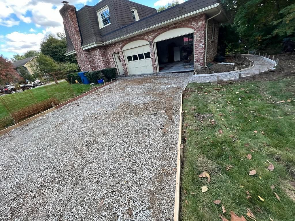 Driveway prepped with gravel base and forms ready for concrete pour